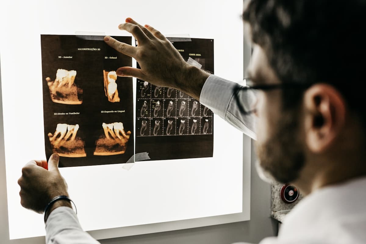A dental professional reviewing diagnostic imaging
