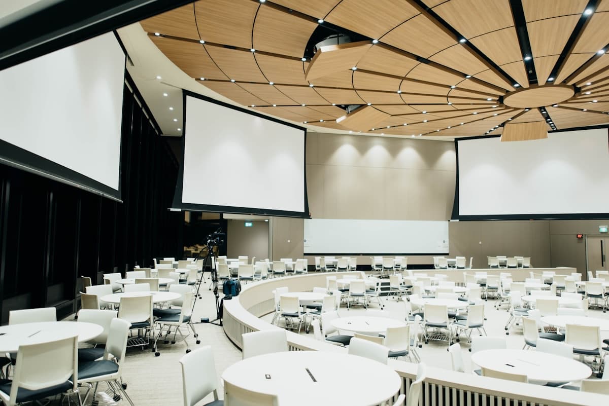 A community event and presentation venue set up with round tables